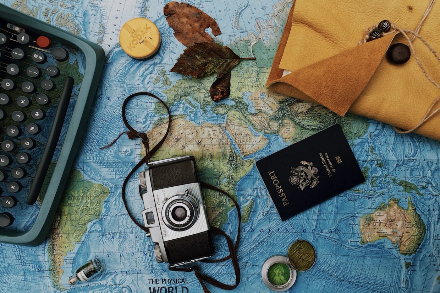 Passport, camera, and travel documents laid flat